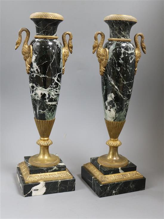 A pair of marble urns and mounts